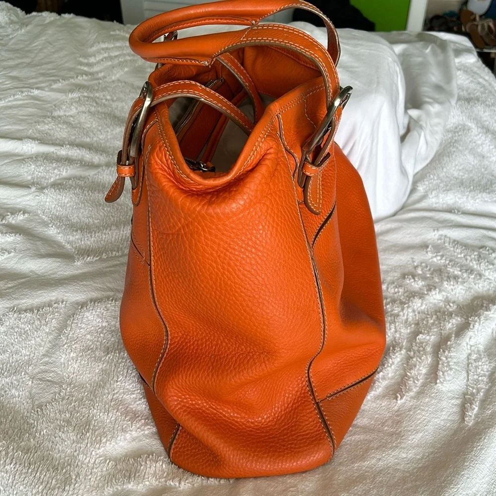 Large leather Cole Haan orange shoulder bag with silver hardware buckles. - Picture 3 of 16